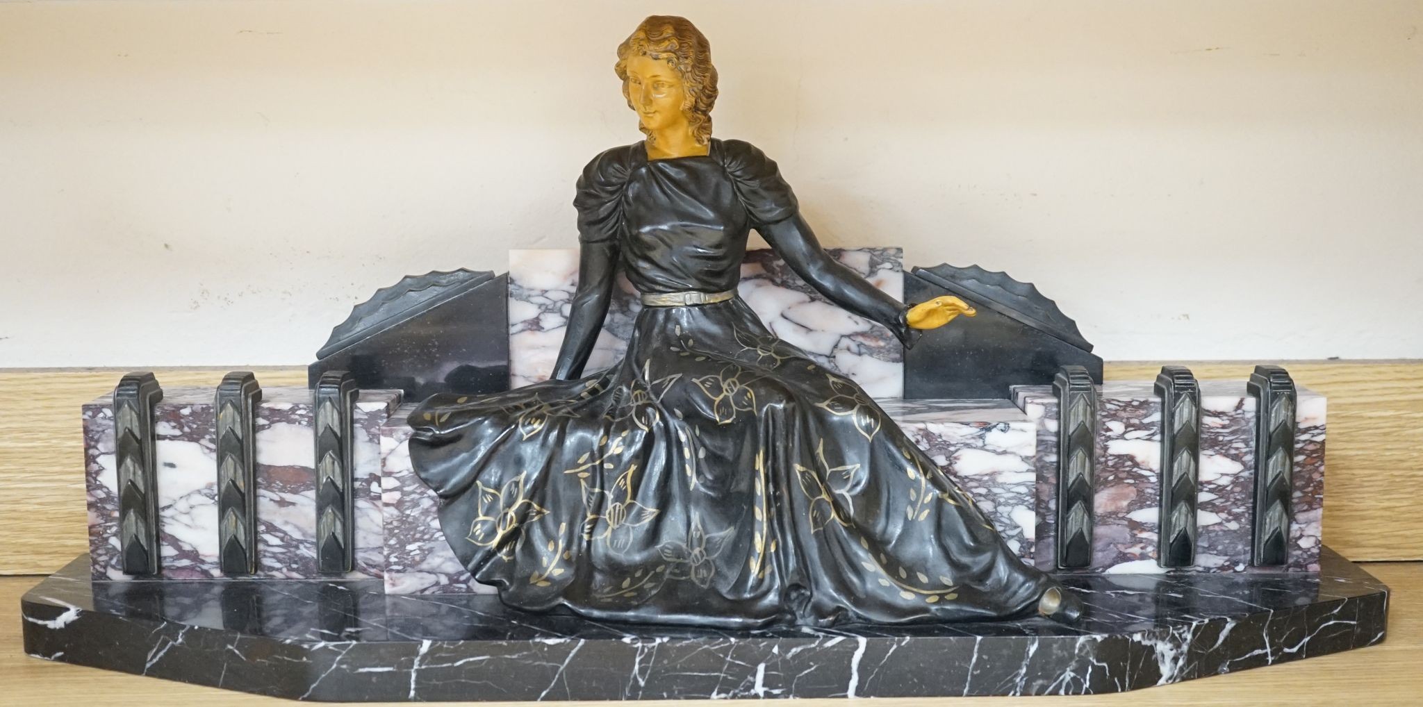 A large Art Deco style marble and spelter figural mantel ornament, 74 cms wide.